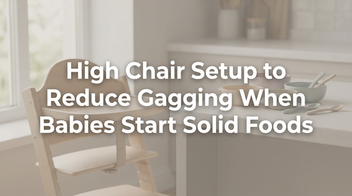 Baby sitting upright in high chair being fed with spoon in bright kitchen