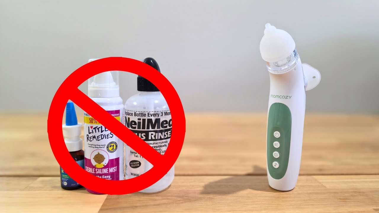 Product comparison showing traditional nasal care products (Little Remedies saline mist and NeilMed sinus rinse) with red prohibition symbol crossed out, next to white and sage green Momcozy electric nasal aspirator on wooden surface