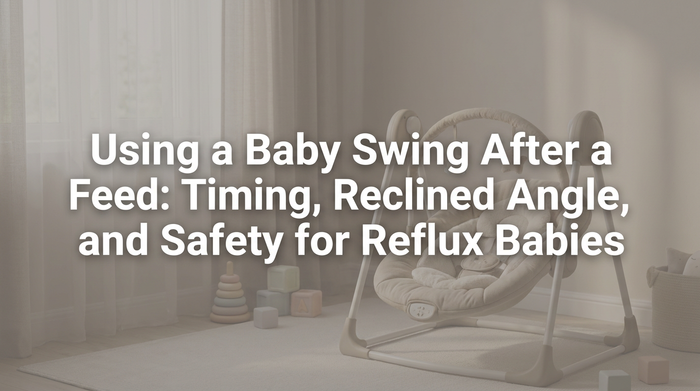 Parent holding baby upright after feeding in softly lit nursery