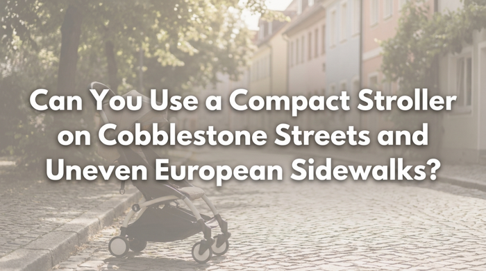 Parent pushing compact stroller on European cobblestone street