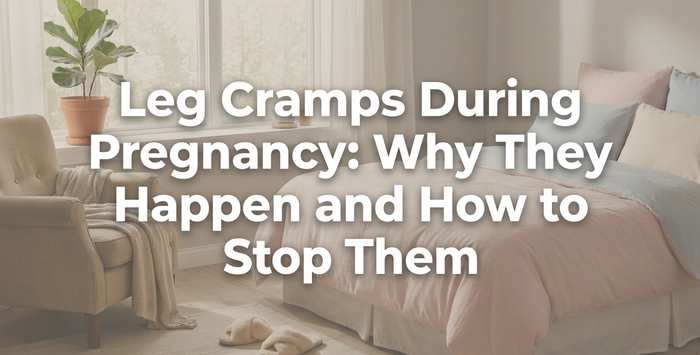 Pregnant woman gently massaging leg cramp at night in soft bedroom light