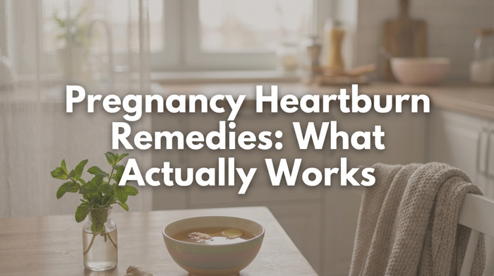 Pregnant woman sitting comfortably at home with hand on chest