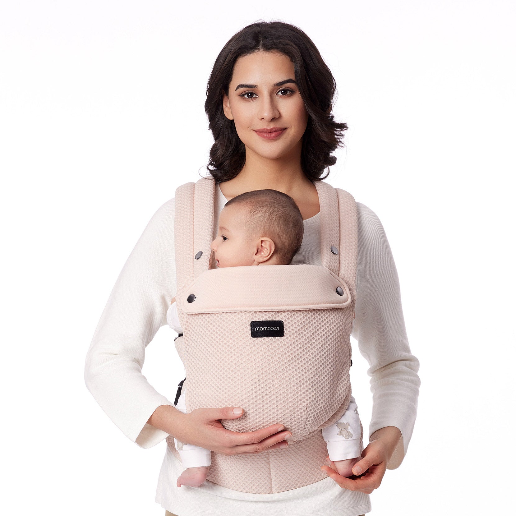Momcozy PureHug baby carrier in beige, mother babywearing. Featuring breathable mesh design, comfortable and supportive.
