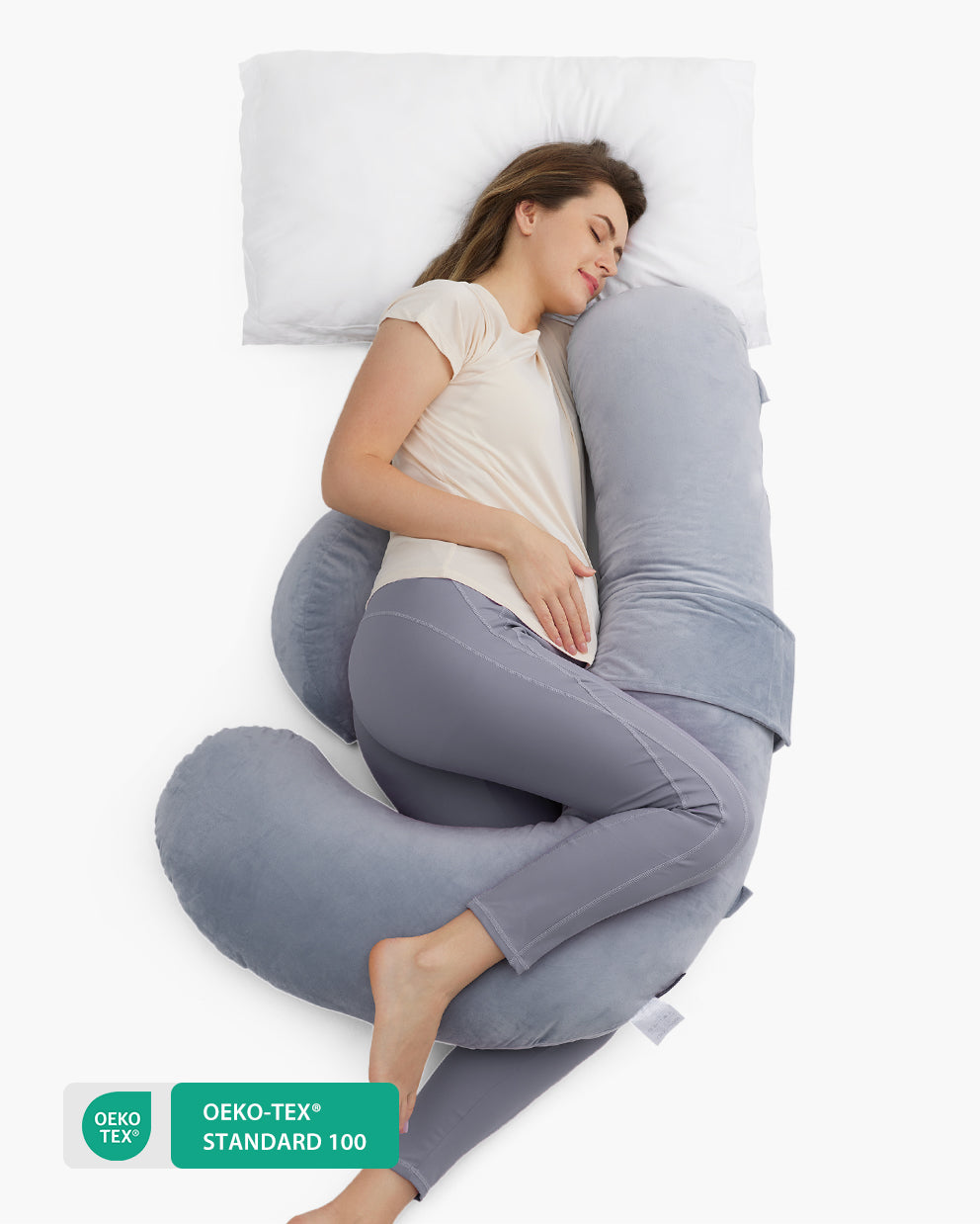 F-shaped pregnancy pillow supporting a pregnant woman. Oeko-Tex Standard 100 certified for safe, comfortable sleep.