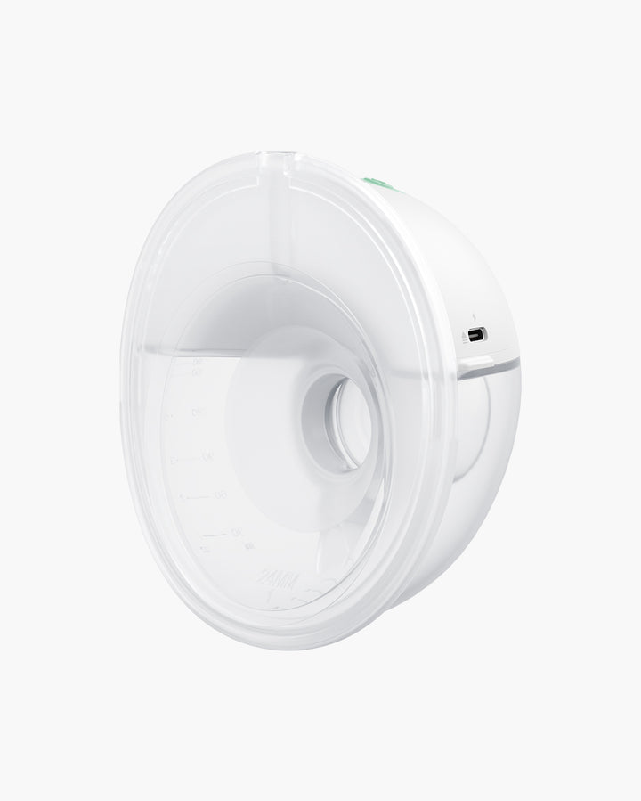 Momcozy M5 wearable breast pump, side view showing clear plastic breast shield and white main body with measurement markings and charging port.