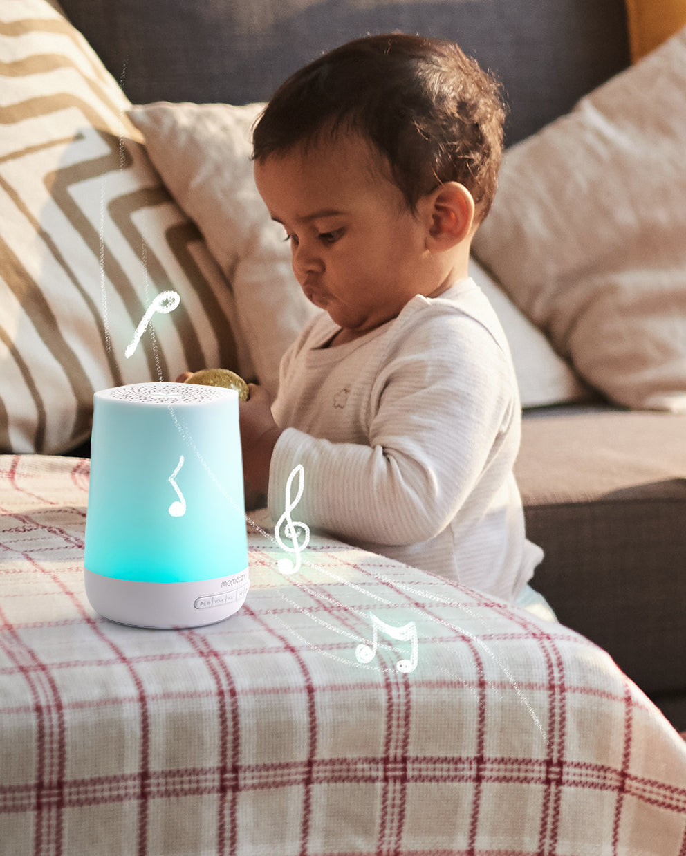 Momcozy Smart Baby Sound Machine with blue night light and musical notes, designed for soothing babies.