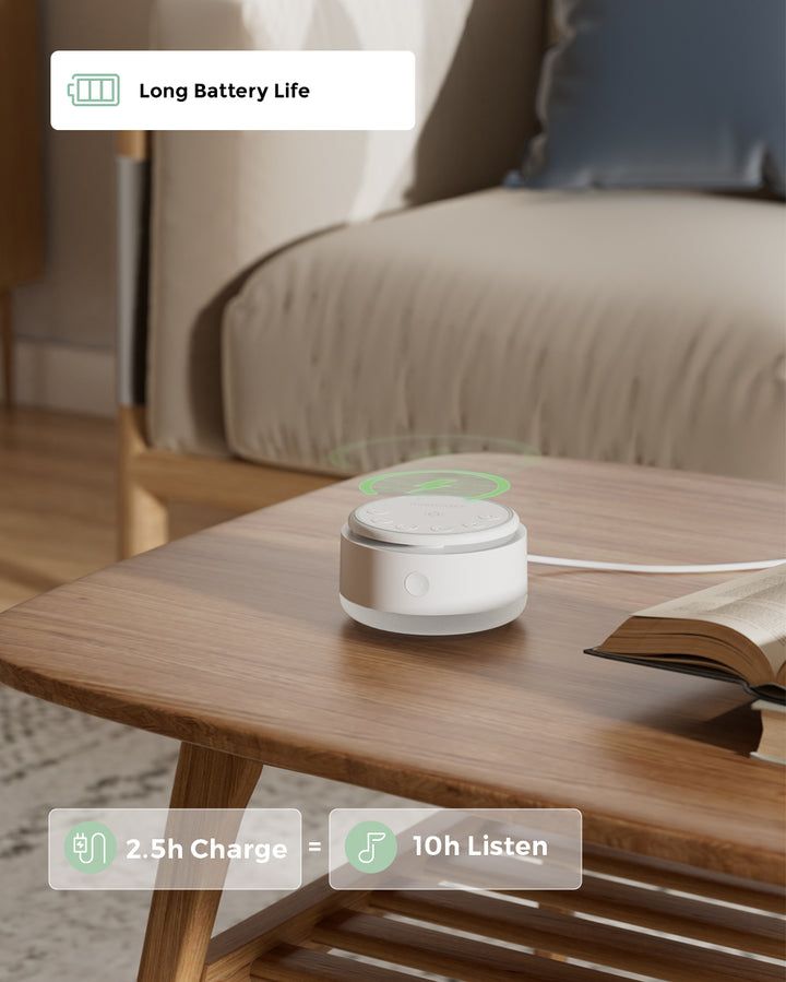 Portable baby sound machine on a wooden table with text highlighting 'Long Battery Life' and '2.5h Charge = 10h Listen'.