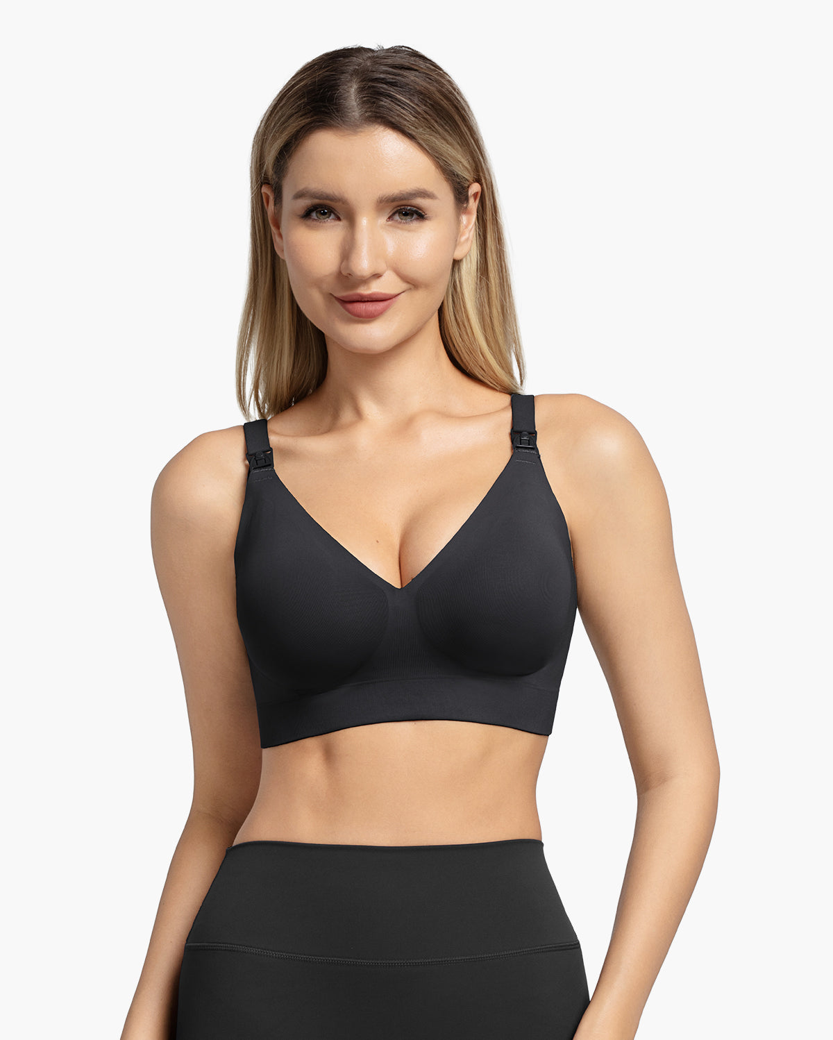 Smiling woman models black Momcozy CoolFit Ultra Stretch nursing bra, highlighting seamless V-neck and functional clips.