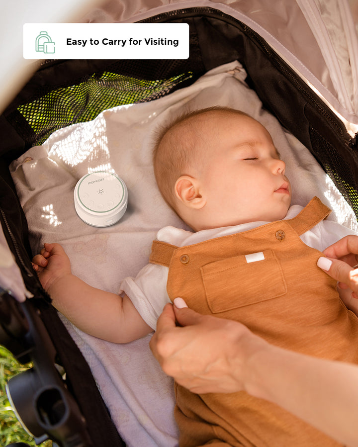 Sleeping baby in a stroller with a portable baby sound machine nearby, and a hand adjusting the baby’s blanket. Text 'Easy to Carry for Visiting' is displayed in the corner.