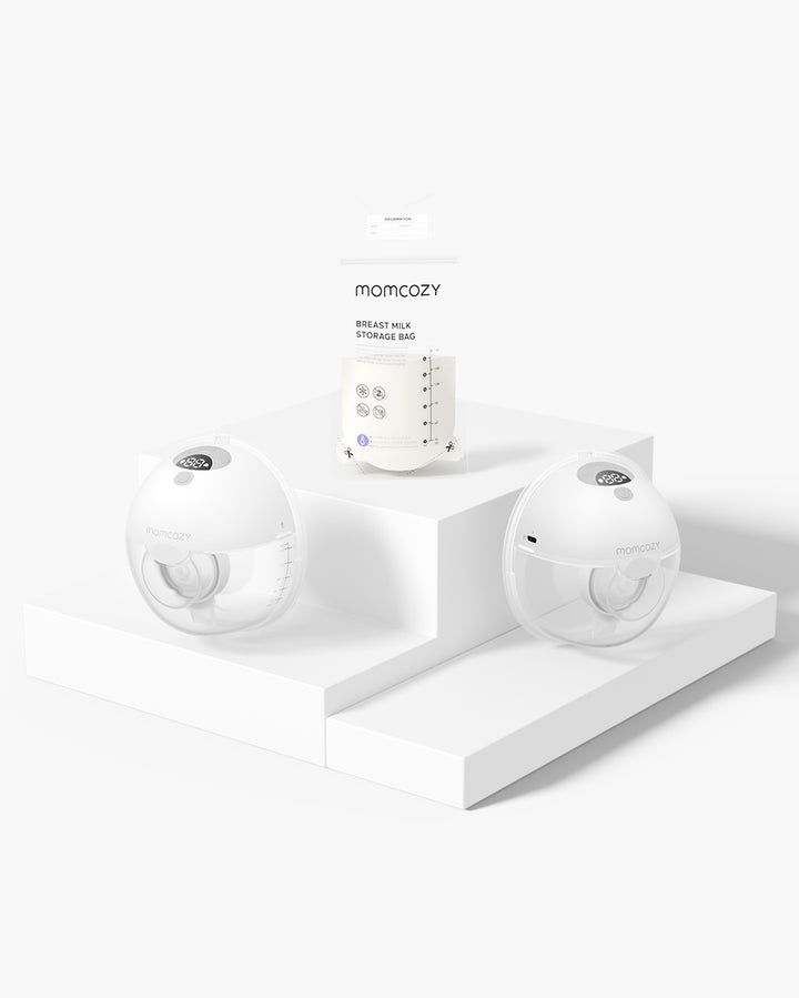 Momcozy M5 Wearable Breast Pump set with breast milk storage bags on a white platform