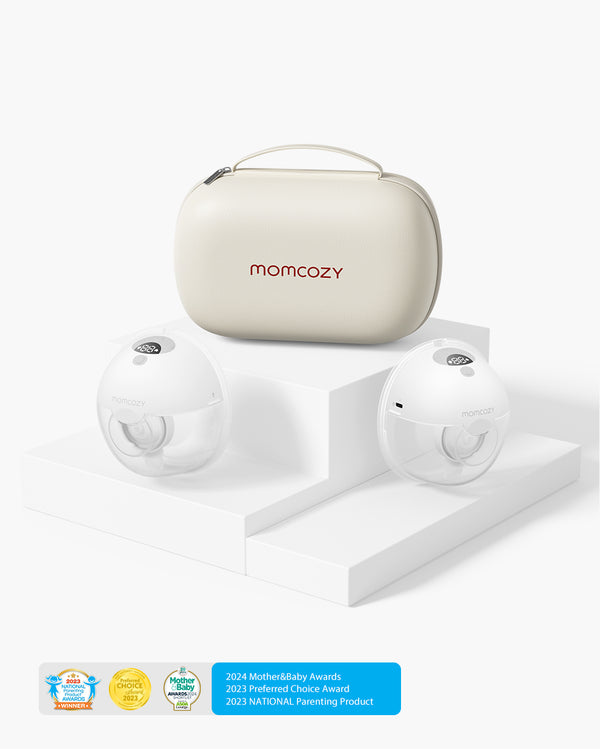 Momcozy M5 Wearable Breast Pump set displayed on a white tiered platform, featuring two transparent breast pumps and a beige carrying case with the Momcozy logo. Awards at the bottom highlight the 2024 Mother&Baby Awards, 2023 Preferred Choice Award, and 2023 National Parenting Product.