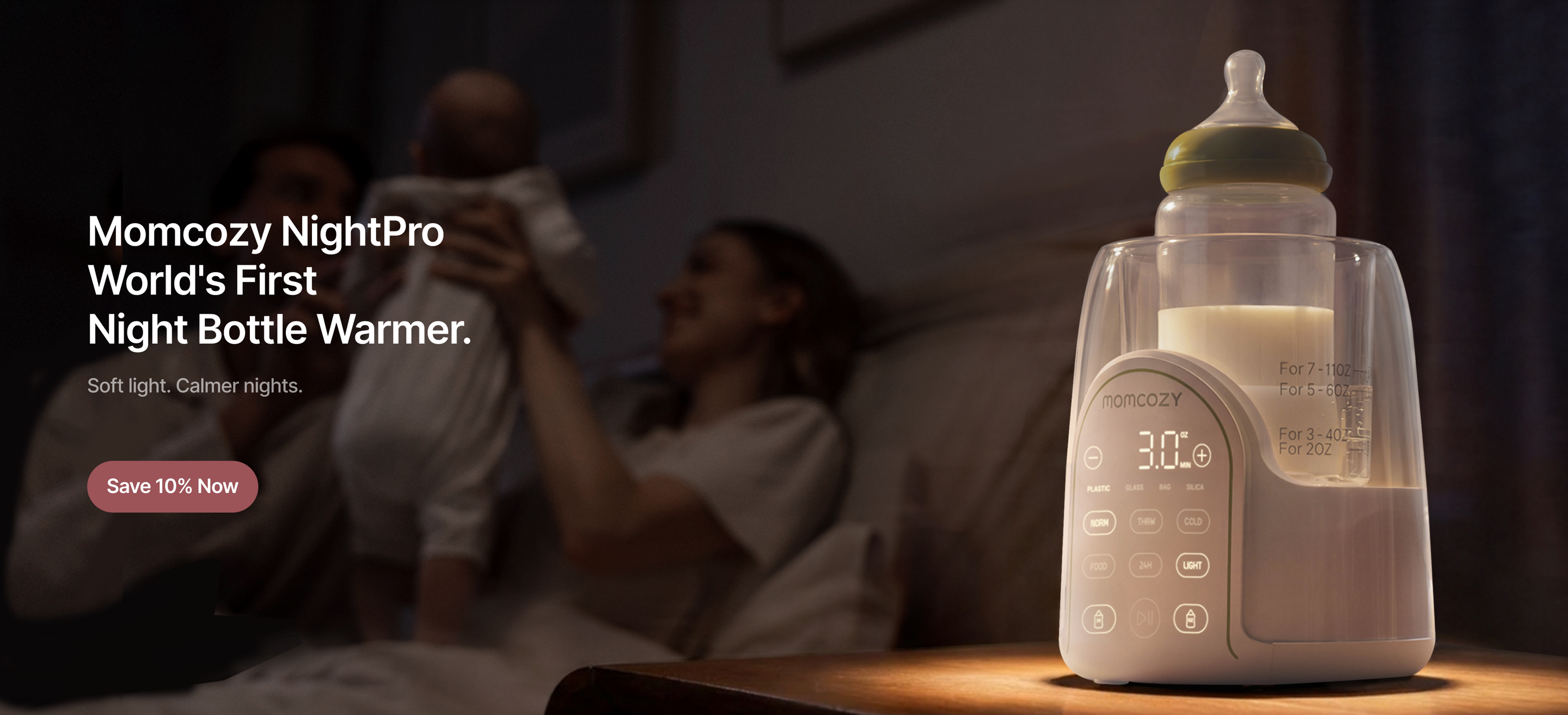 Momcozy NightPro bottle warmer with a woman holding a baby. Momcozy NightPro World's First Night Bottle Warmer. Soft light. Calmer nights.