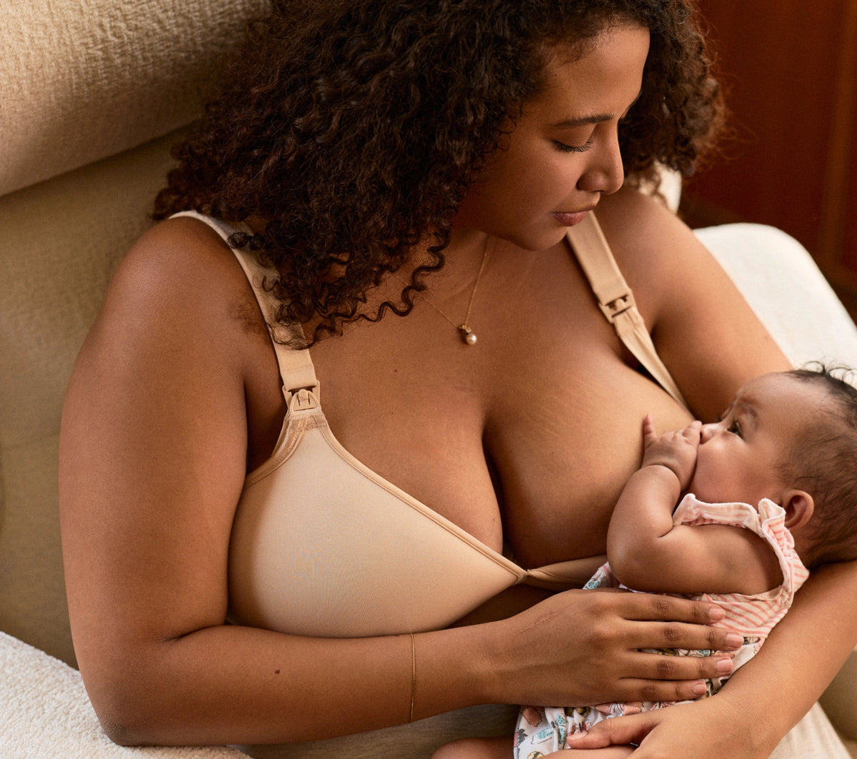 A mother nursing her baby in bed