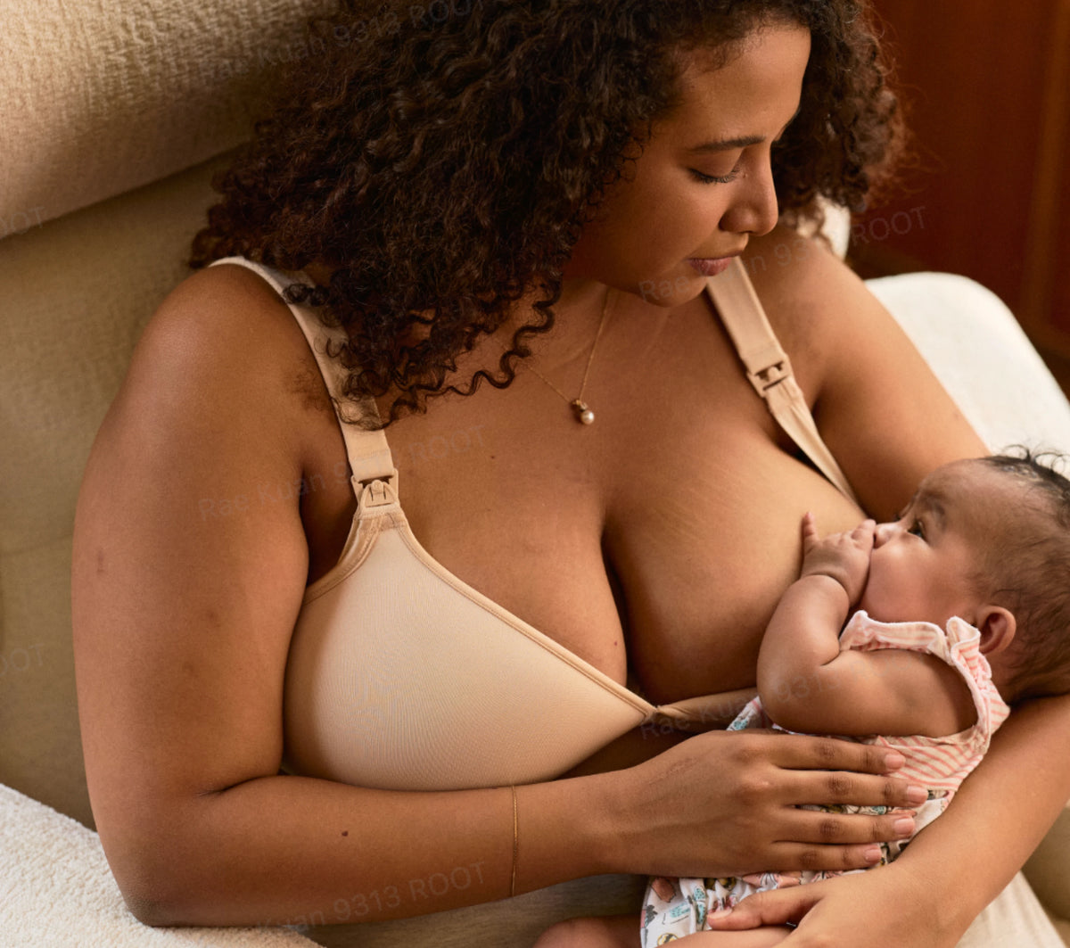 A mother nursing her baby in bed
