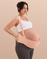 Pregnant woman wearing the Momcozy Go As You Grow maternity belly band in oyster pink with adjustable shoulder straps.