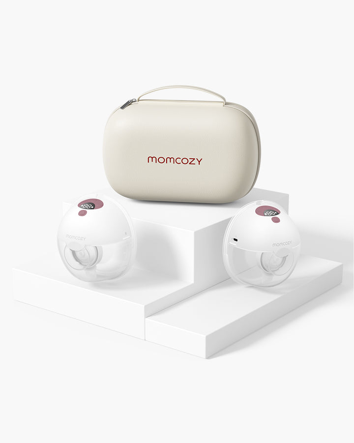 Momcozy M5 Wearable Breast Pump set with beige storage case on a white stepped platform