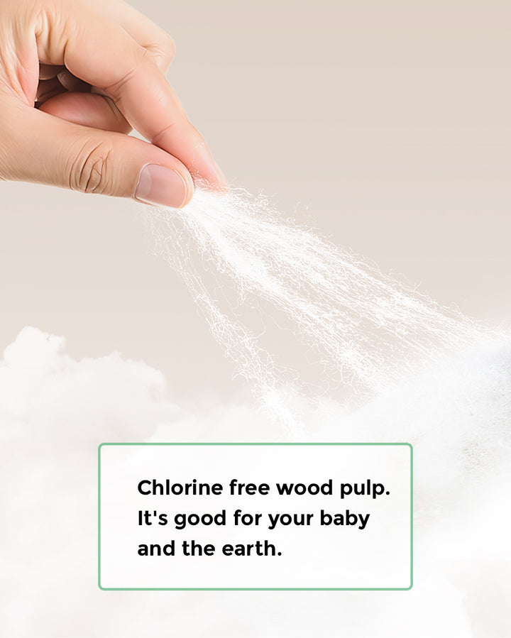 Hand holding chlorine-free wood pulp with text 'Chlorine free wood pulp. It's good for your baby and the earth.' for BabyCozy Softest Diapers