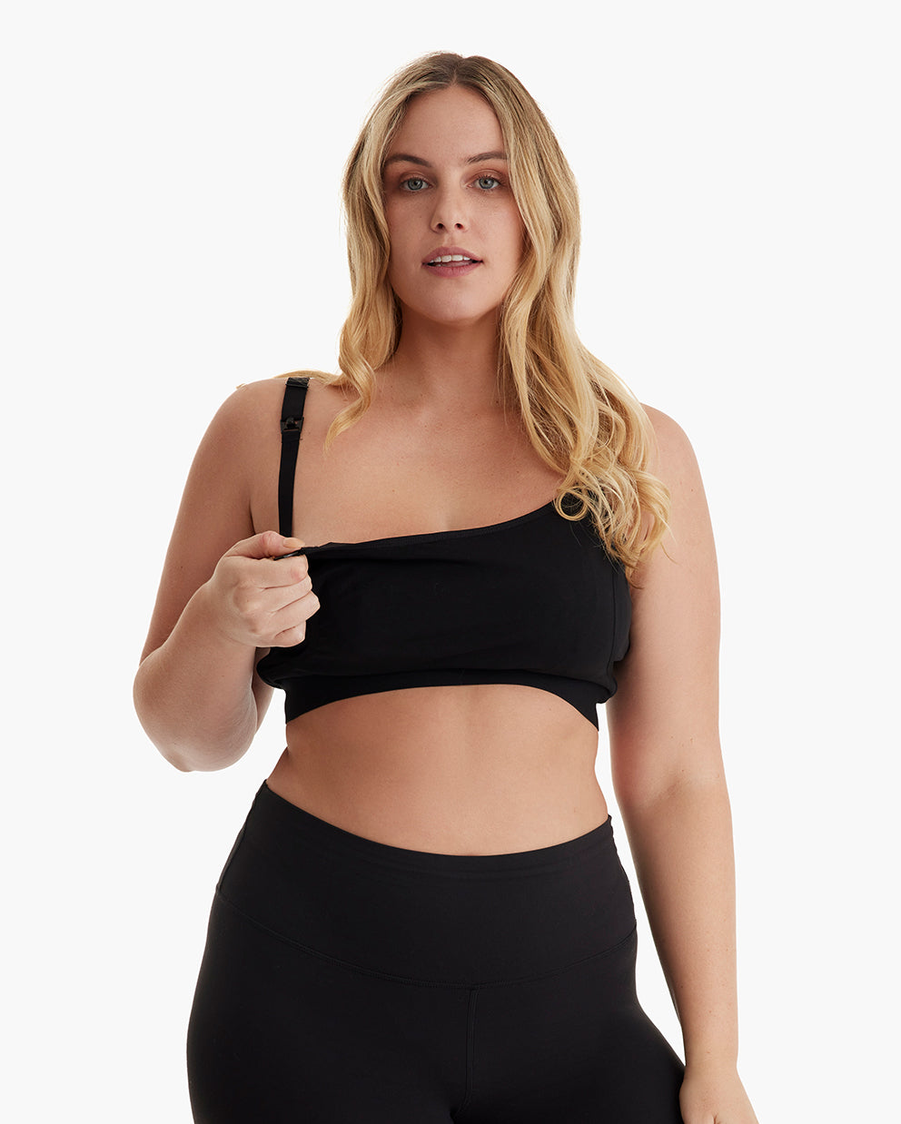 Diverse blonde model showcases black YN08 pumping bra's drop-down nursing access and comfortable fit.